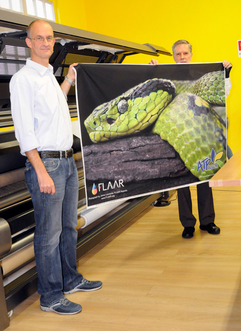 Dr. Nicholas Helmuth holding snake printed onto textile at ATPColor demo room visit.