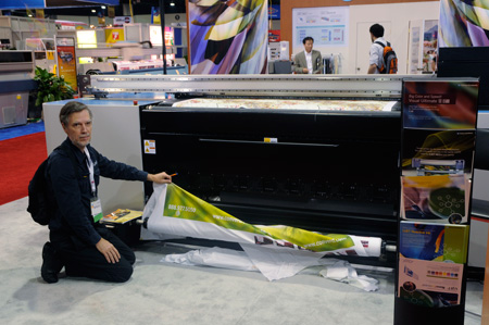 Nicholas with some printing examples of the Yuhan VU-1800 textile printer at SGIA 2008. 