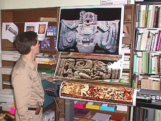 Encad wide format ink jet printer in FLAAR office with three posters of Maya art and archaeology.
